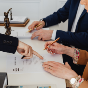 Hands collecting documents and phone for legal defense preparation