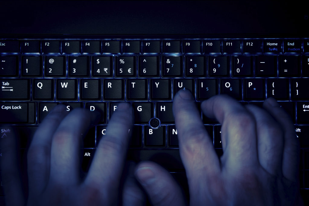 What is Enticing a Minor? - Wasatch Defense Lawyers Typing on a Keyboard - What is Enticing a Minor?